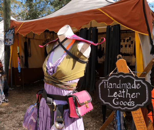 Merchant tent selling handmade leather goods.