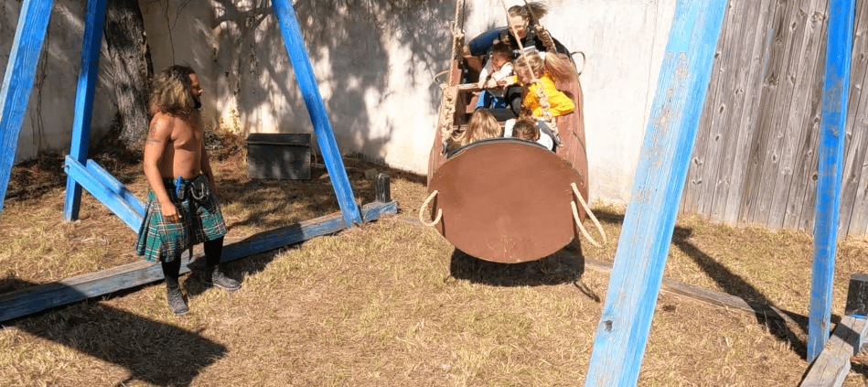 Kids on a barrel swing.