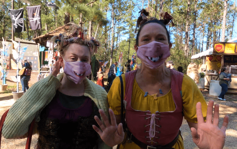 Washing Well Wenches with masks that have their own smiling faces.