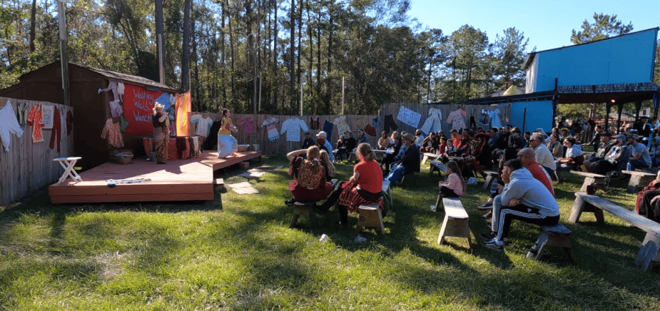 Spectators watching the Washing Well Wenches outdoor performance.