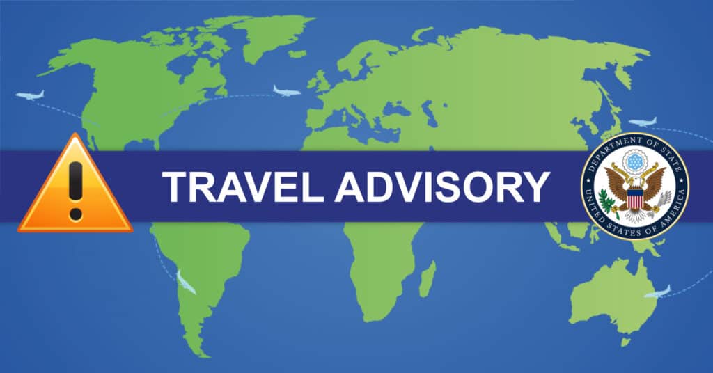 An updated travel advisory sign displaying Israel on a blue background with a world map.