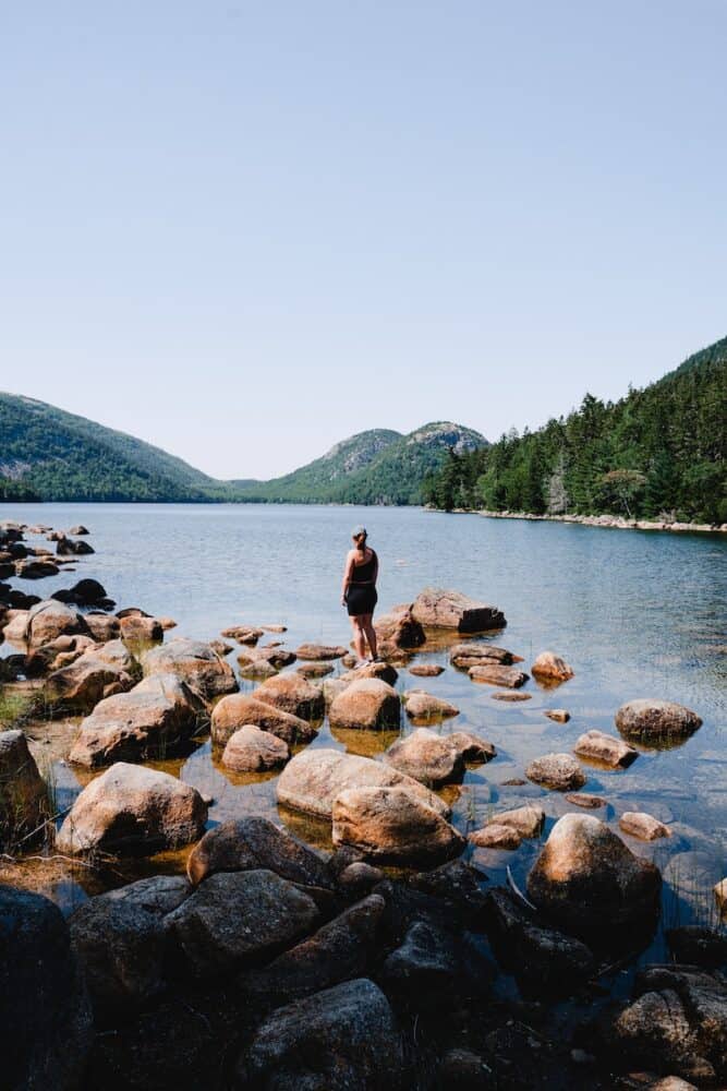 a person standing on a rocky shore