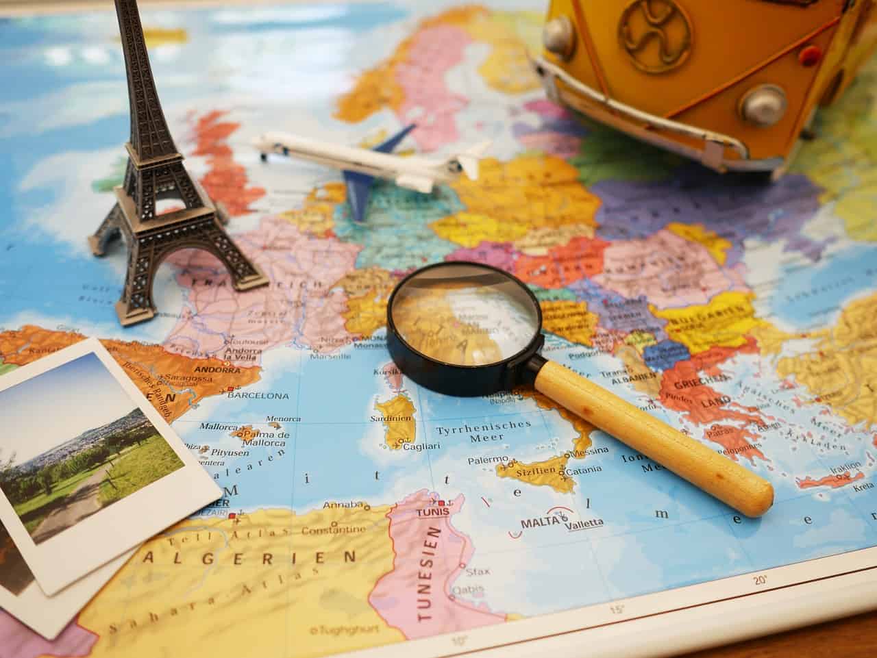 A magnifying glass on top of a detailed map of Europe, perfect for travel planning.